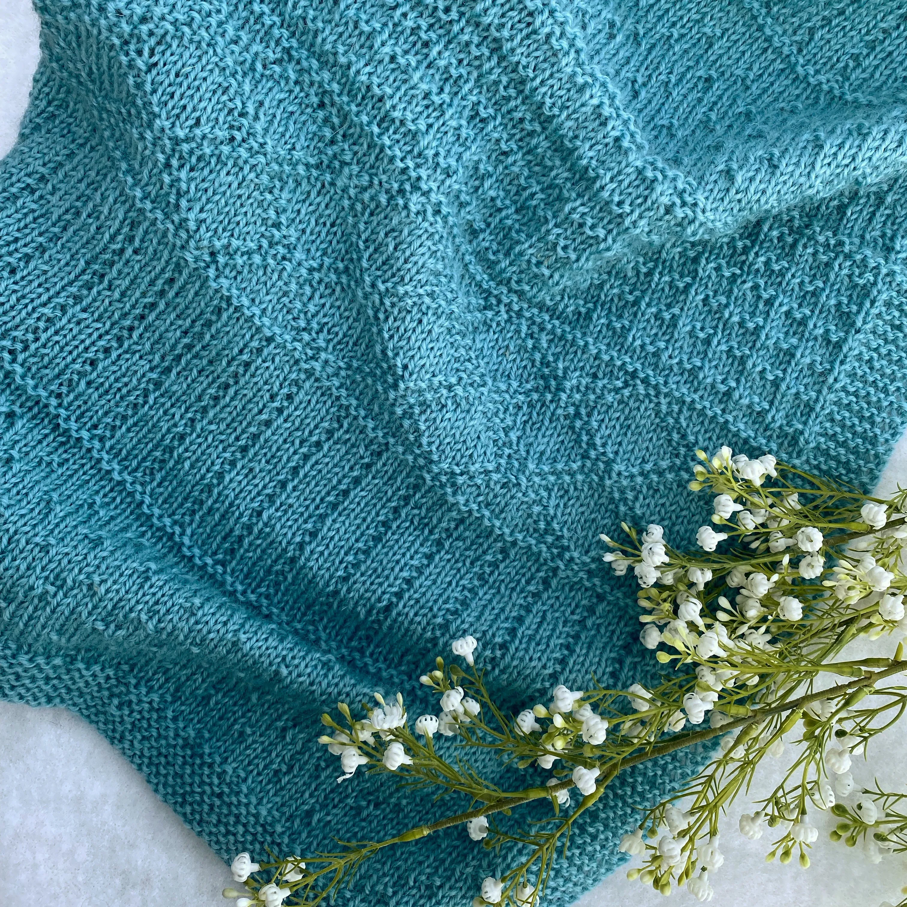 "Daisy" hand knit merino baby cot blanket